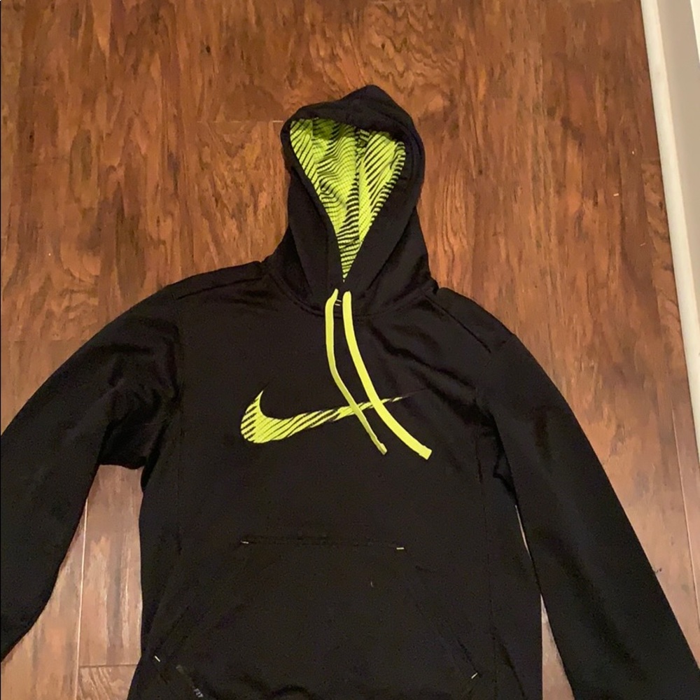 A black and neon green Nike sweatshirt .